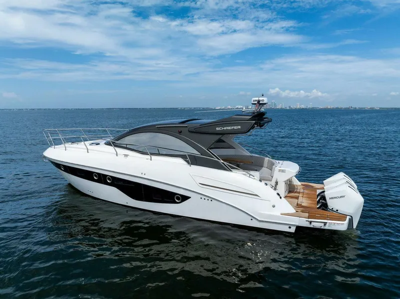Slide: The Image of 2022 Schaefer 400 Coupe yacht on open water under blue sky. - 41