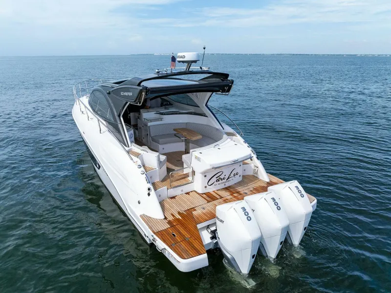 Slide: The Image of 2022 Schaefer 400 Coupe yacht on open water, featuring triple outboard engines. - 42