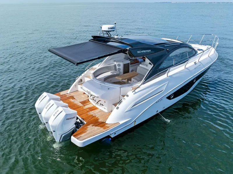 Slide: The Image of 2022 Schaefer 400 Coupe yacht on open water, featuring sleek design and twin engines. - 43