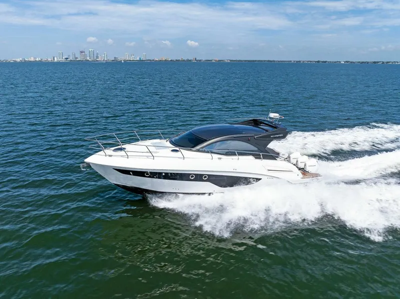Slide: The Image of 2022 Schaefer 400 Coupe yacht cruising on open water under clear skies. - 45