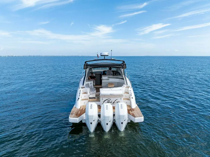 Slide: The Image of Schaefer 400 Coupe 2022 yacht on open water, rear view with triple engines. - 48