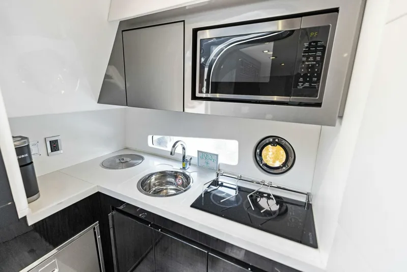 Slide: The Image of Modern kitchen in 2022 Schaefer 400 Coupe yacht with microwave and sink. - 9