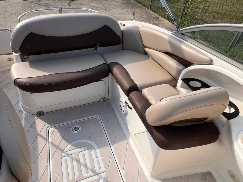 Slide: The Image of 2005 Monterey 220 Explorer Sport boat interior with beige and brown seating. - 8