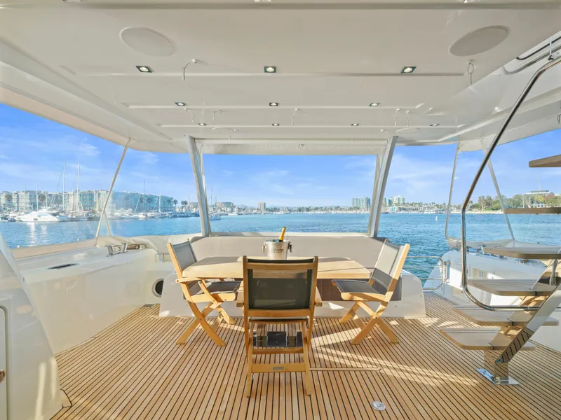 Slide: The Image of Luxurious 2018 Prestige 680 yacht deck with dining area overlooking serene marina. - 13
