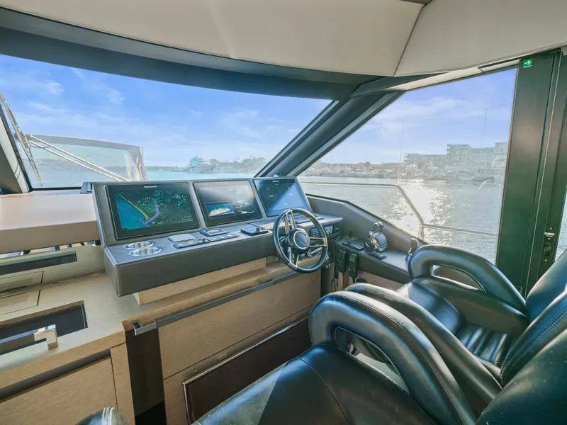 Slide: The Image of Luxurious 2018 Prestige 680 yacht cockpit with modern navigation system and leather seating. - 17