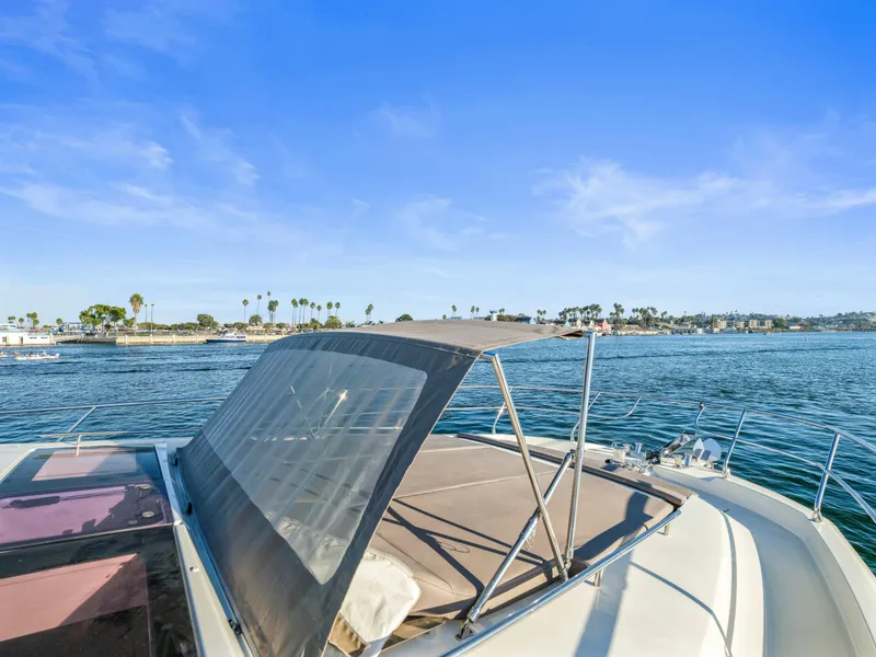 Slide: The Image of Prestige 680 yacht on serene water, 2018 model, clear blue sky backdrop. - 18