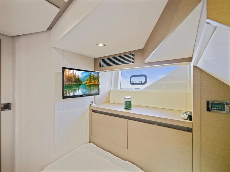 Slide: The Image of Luxurious interior of 2018 Prestige 680 yacht cabin with TV and window view. - 47