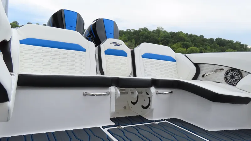 Slide: The Image of 2023 Sunsation 32 CCX boat interior with blue and white seating, dual engines, and sleek design. - 14