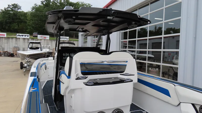 Slide: The Image of 2023 Sunsation 32 CCX boat with sleek design and modern features, docked outdoors. - 15