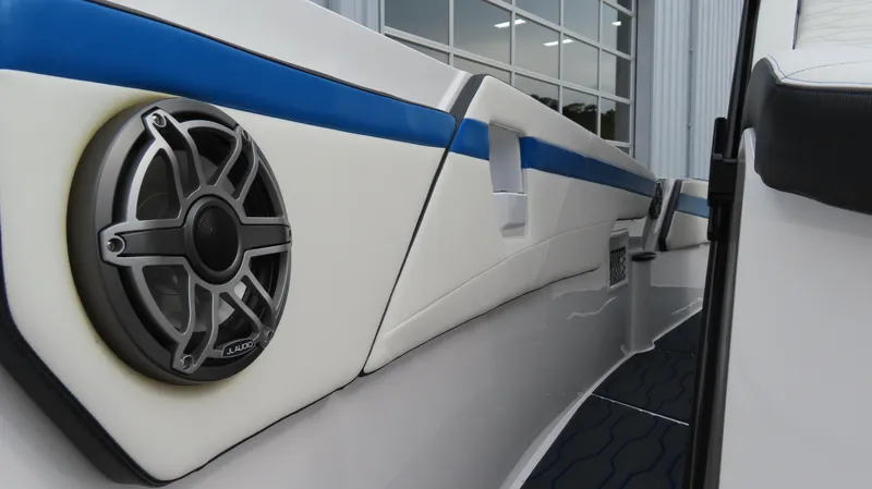 Slide: The Image of 2023 Sunsation 32 CCX boat interior with speaker and blue accent stripe. - 26