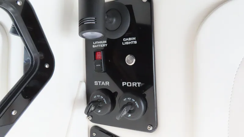 Slide: The Image of Control panel of 2023 Sunsation 32 CCX boat with switches and dials. - 9