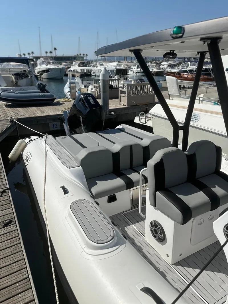 Slide: The Image of 2025 Aqvaboats Luxrib 25 docked at marina, featuring sleek design and modern seating. - 11