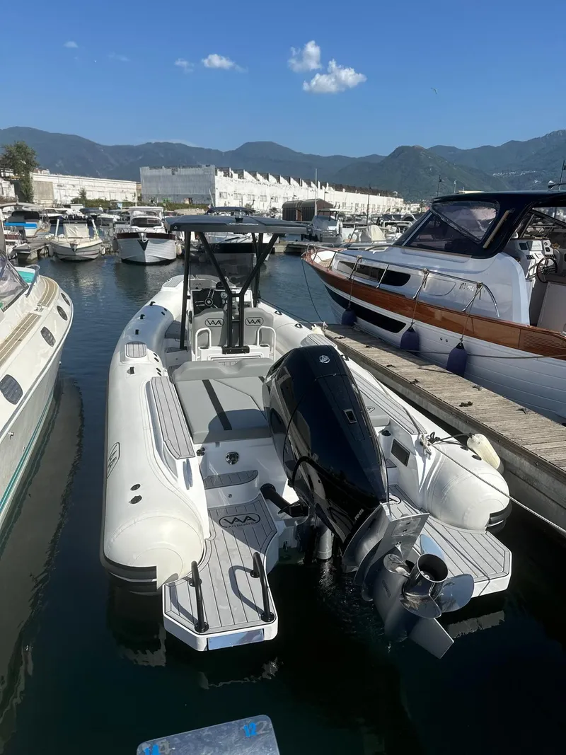 Slide: The Image of 2025 Aqvaboats Luxrib 25 docked in a marina, surrounded by other boats. - 7