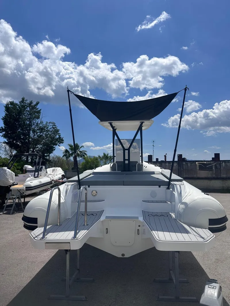 Slide: The Image of Aqvaboats Luxrib 25, 2025 model, docked under a sunny sky. - 8