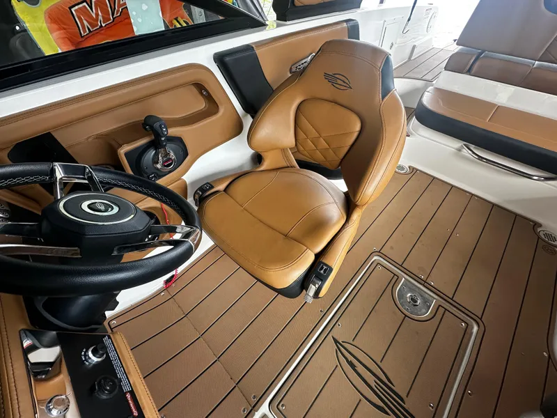 Slide: The Image of Interior of a 2021 Chaparral 26 Surf boat with brown leather seats. - 10