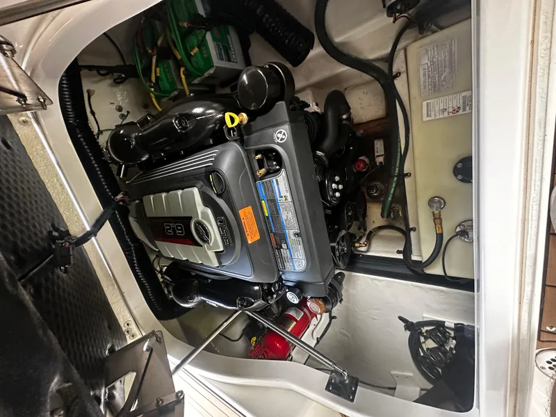 Slide: The Image of Engine compartment of 2021 Chaparral 26 Surf with visible engine. - 13