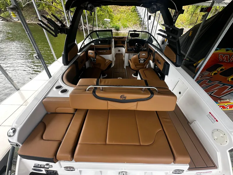 Slide: The Image of Interior view of 2021 Chaparral 26 Surf boat with luxurious leather seating. - 2