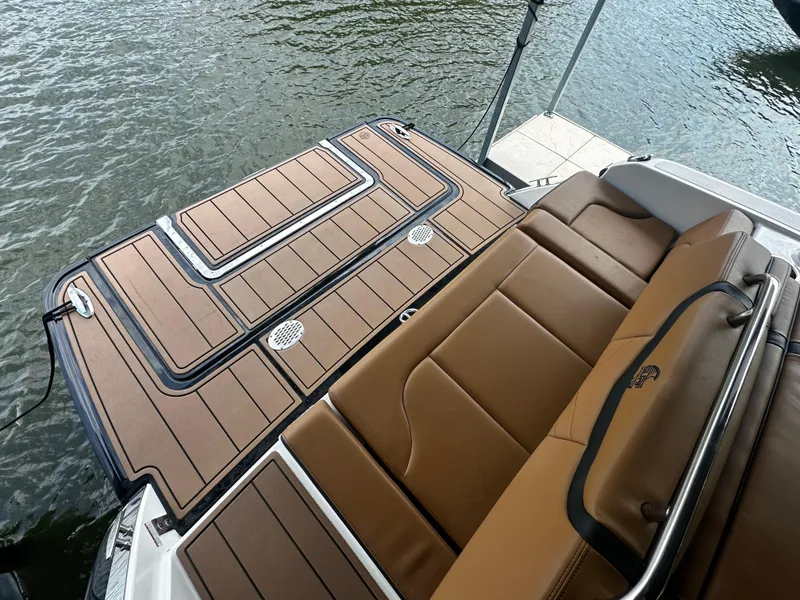 Slide: The Image of Chaparral 26 Surf 2021 boat with brown deck and seating area. - 3