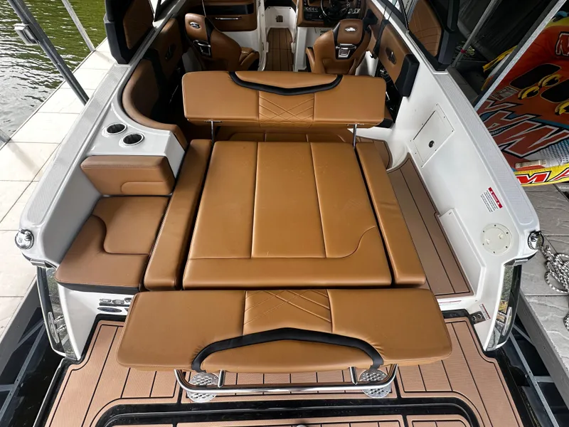 Slide: The Image of Interior of 2021 Chaparral 26 Surf with brown leather seating. - 4