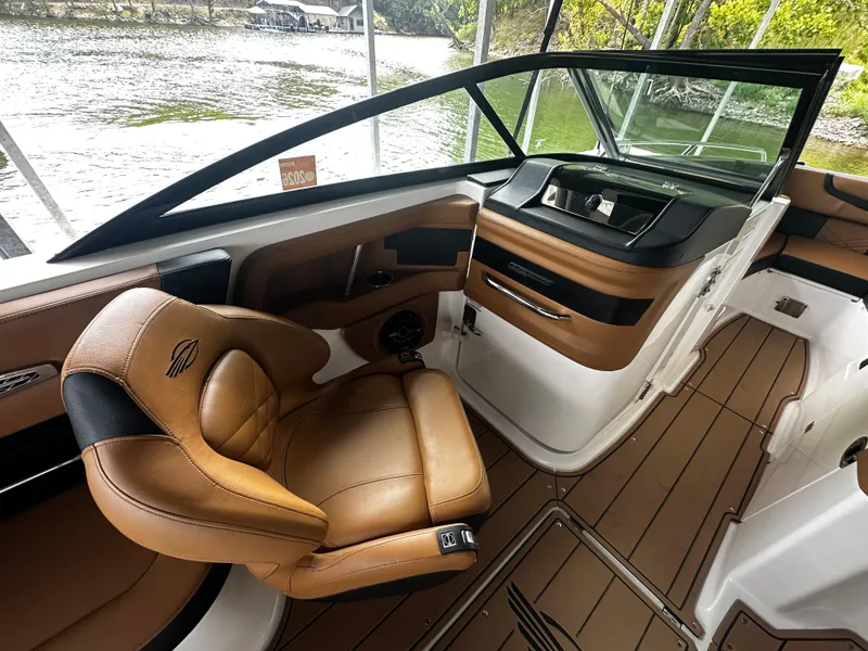 Slide: The Image of Interior of a 2021 Chaparral 26 Surf boat with brown leather seats. - 5