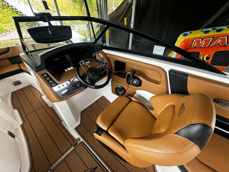 Slide: The Image of Interior of a 2021 Chaparral 26 Surf boat with brown leather seats. - 6