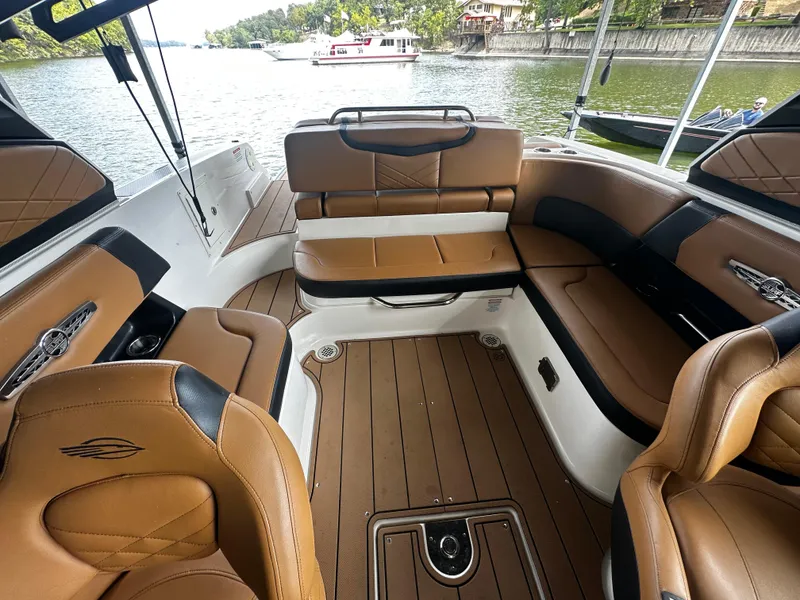 Slide: The Image of Interior of a 2021 Chaparral 26 Surf boat with brown leather seating. - 7