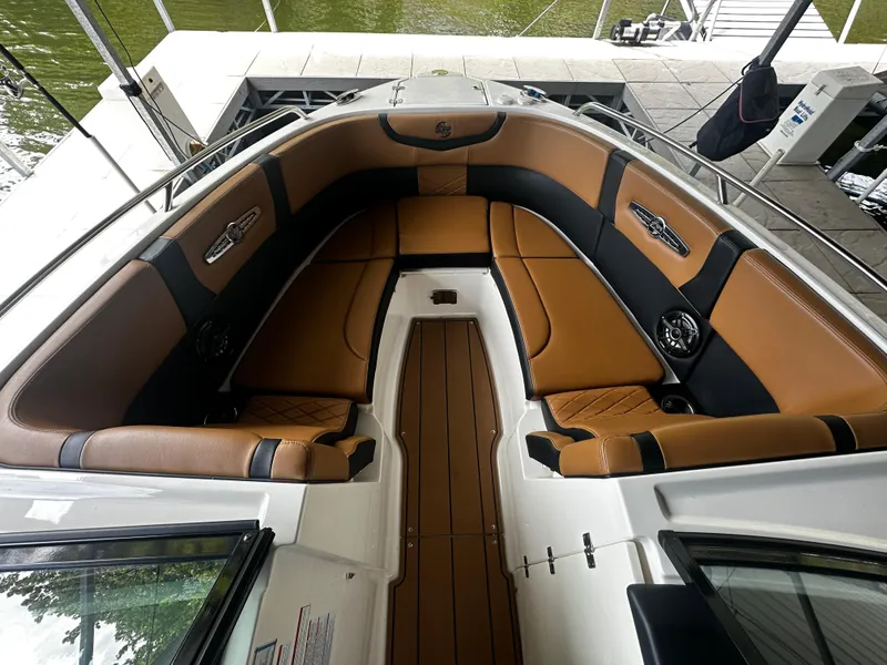Slide: The Image of Interior of a 2021 Chaparral 26 Surf boat with brown seating. - 8