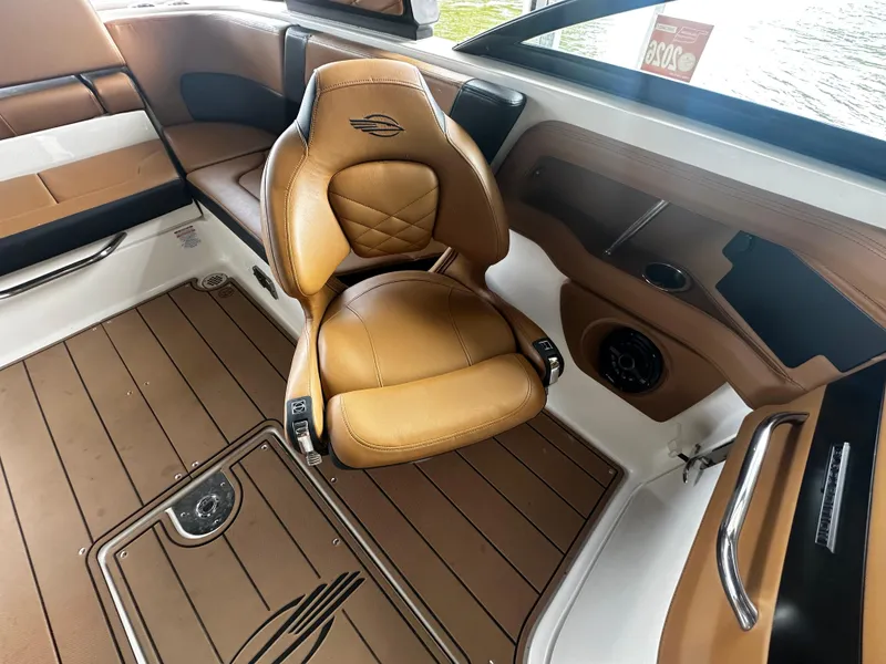 Slide: The Image of Interior of a 2021 Chaparral 26 Surf boat with brown leather seating. - 9