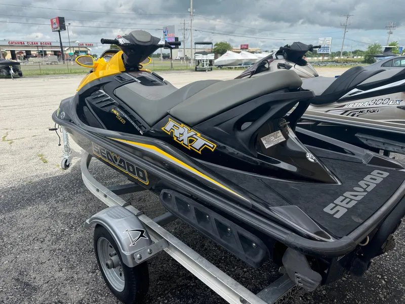 Slide: The Image of 2007 Sea-Doo RXT jet ski on trailer, parked outdoors. - 2