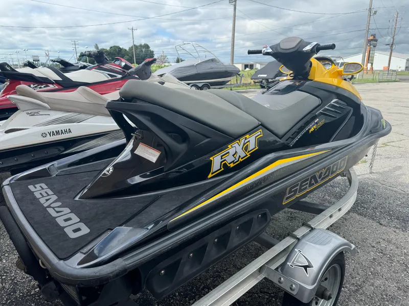 Slide: The Image of 2007 Sea-Doo RXT jet ski on trailer, black and yellow design. - 3