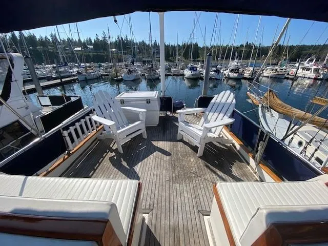 Slide: The Image of 1973 Grand Banks 42 Classic yacht deck with seating, overlooking marina. - 11
