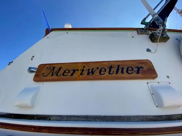 Slide: The Image of 1973 Grand Banks 42 Classic boat with "Meriwether" nameplate, viewed from below. - 13