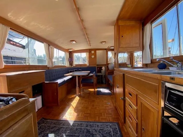 Slide: The Image of Interior of a 1973 Grand Banks 42 Classic yacht with wooden furnishings and seating area. - 16