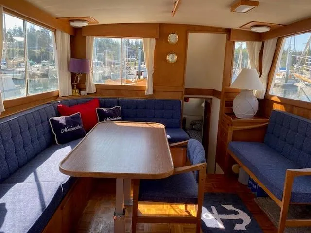 Slide: The Image of Interior of 1973 Grand Banks 42 Classic yacht with blue seating and wooden table. - 20