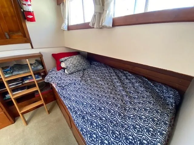Slide: The Image of Cozy cabin bed in 1973 Grand Banks 42 Classic yacht with patterned bedding and wooden accents. - 27