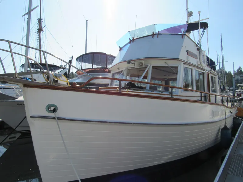 Slide: The Image of 1973 Grand Banks 42 Classic yacht docked in a marina, showcasing its timeless design. - 3