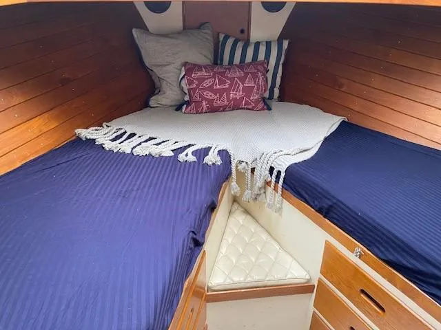 Slide: The Image of Cozy cabin interior of 1973 Grand Banks 42 Classic with blue bedding and nautical decor. - 31