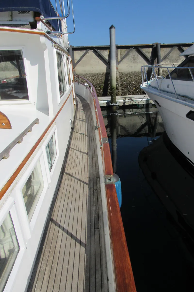 Slide: The Image of 1973 Grand Banks 42 Classic yacht docked beside another boat. - 34