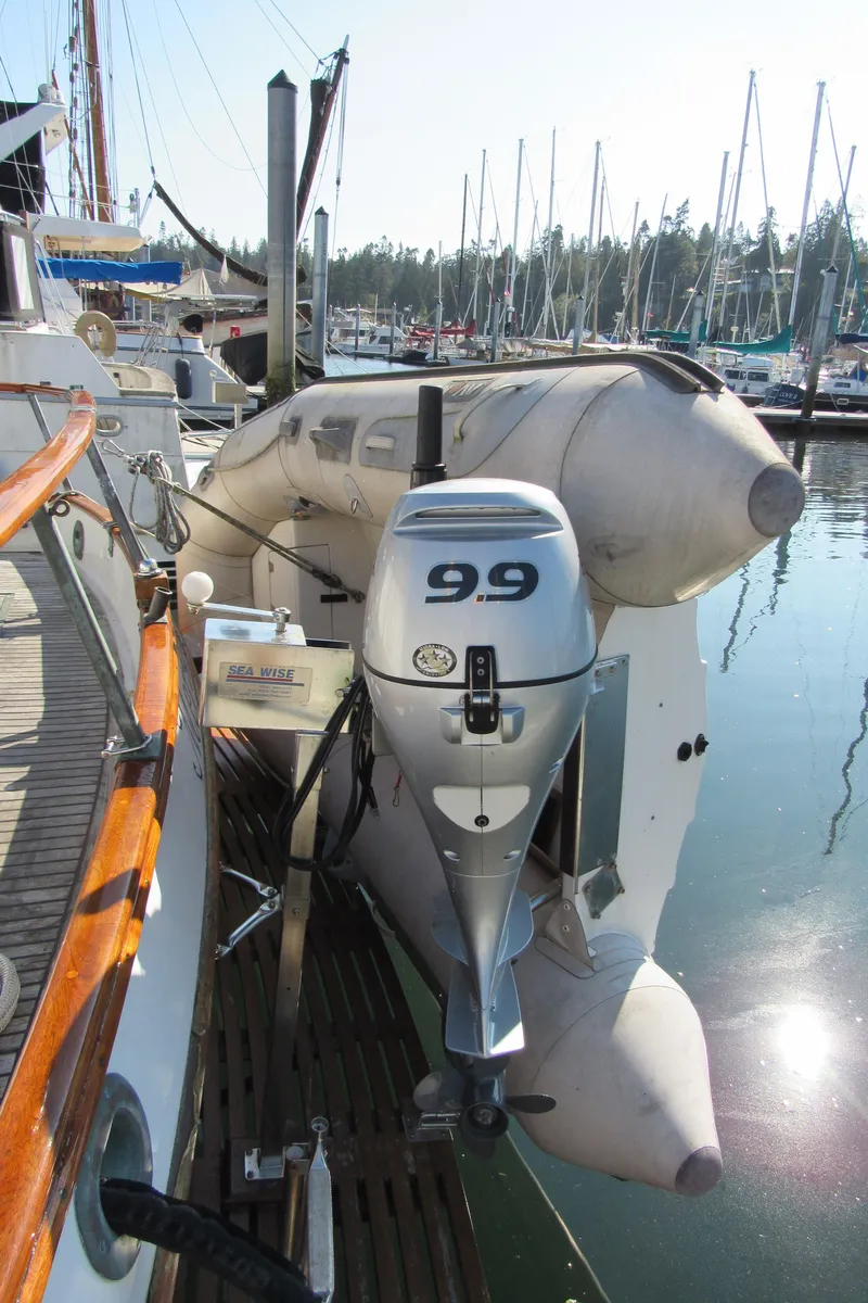 Slide: The Image of 1973 Grand Banks 42 Classic with inflatable dinghy and outboard motor in marina. - 36