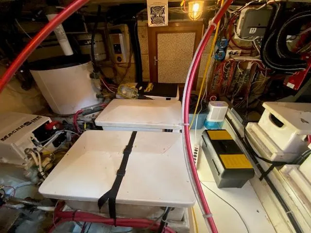 Slide: The Image of Engine room of a 1973 Grand Banks 42 Classic boat, featuring machinery and wiring. - 39