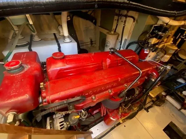 Slide: The Image of Engine room of a 1973 Grand Banks 42 Classic with a red marine engine. - 43