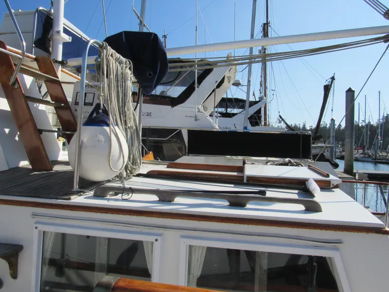 Slide: The Image of 1973 Grand Banks 42 Classic yacht docked at marina, featuring deck details and nautical equipment. - 5
