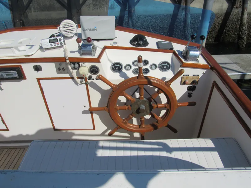 Slide: The Image of Helm of 1973 Grand Banks 42 Classic with wooden wheel and navigation instruments. - 9