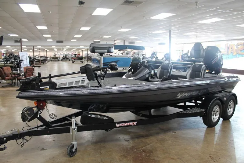 Slide: The Image of 2025 Phoenix 818 Pro boat on trailer in showroom, featuring sleek design and modern equipment. - 6