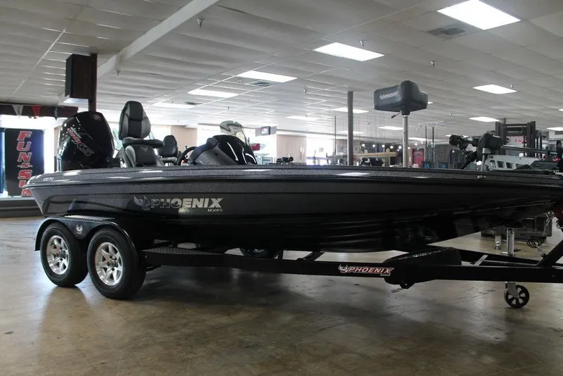 Slide: The Image of 2025 Phoenix 818 Pro boat on trailer in showroom setting. - 8