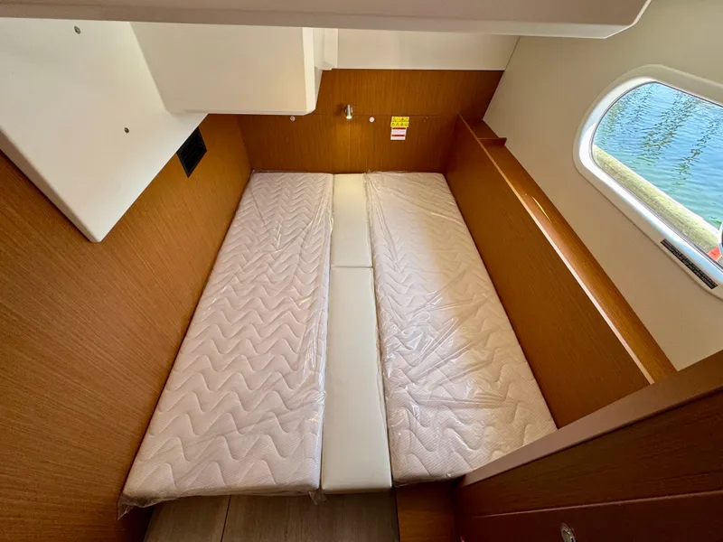 Slide: The Image of 2025 Beneteau Swift Trawler 41 Fly cabin with twin beds and window view. - 11