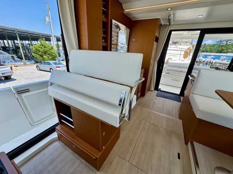 Slide: The Image of Interior of 2025 Beneteau Swift Trawler 41 Fly, featuring modern seating and wood finishes. - 16