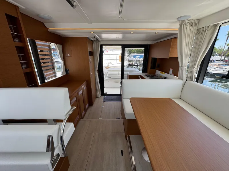 Slide: The Image of Interior of 2025 Beneteau Swift Trawler 41 Fly, featuring modern seating and wood finishes. - 18