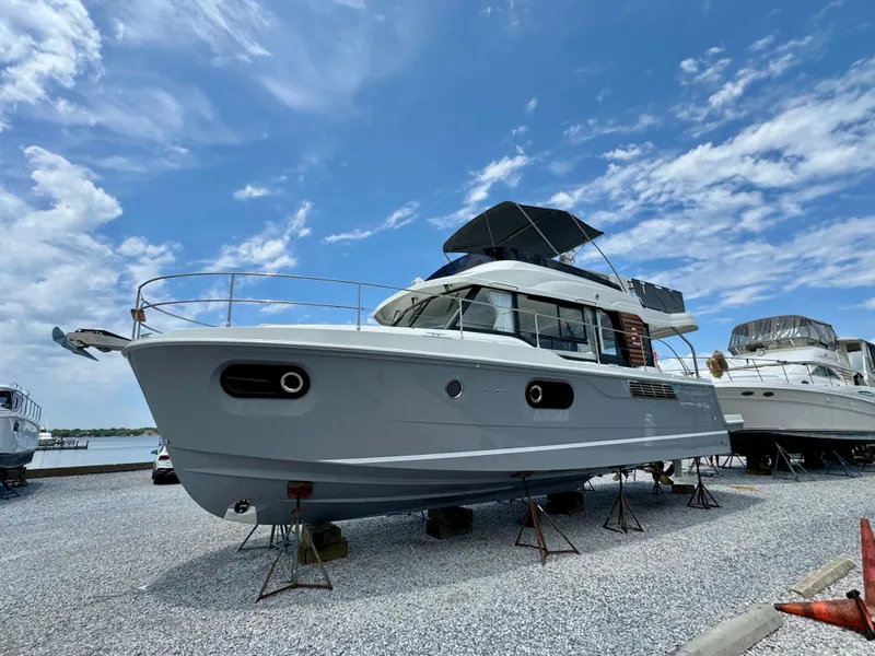 Slide: The Image of 2025 Beneteau Swift Trawler 41 Fly on stands, under a clear blue sky. - 2