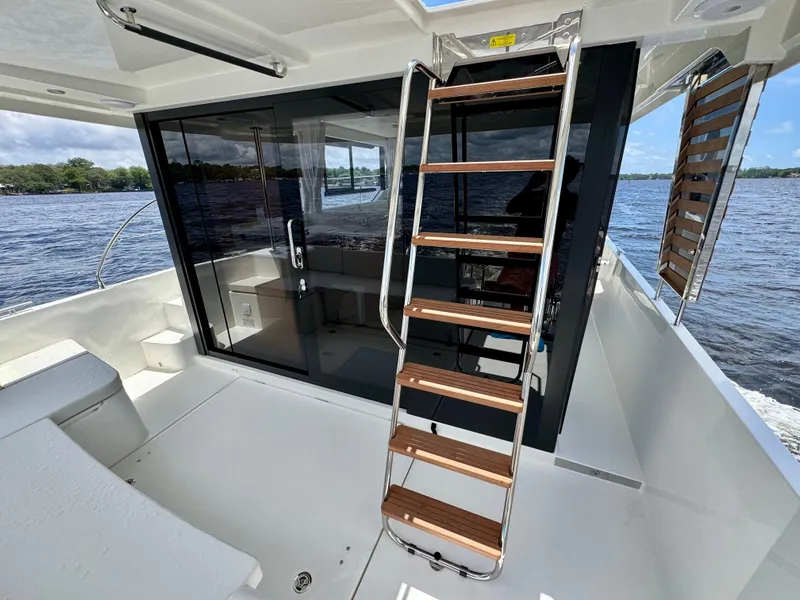 Slide: The Image of 2025 Beneteau Swift Trawler 41 Fly, featuring sleek deck and modern staircase design. - 25